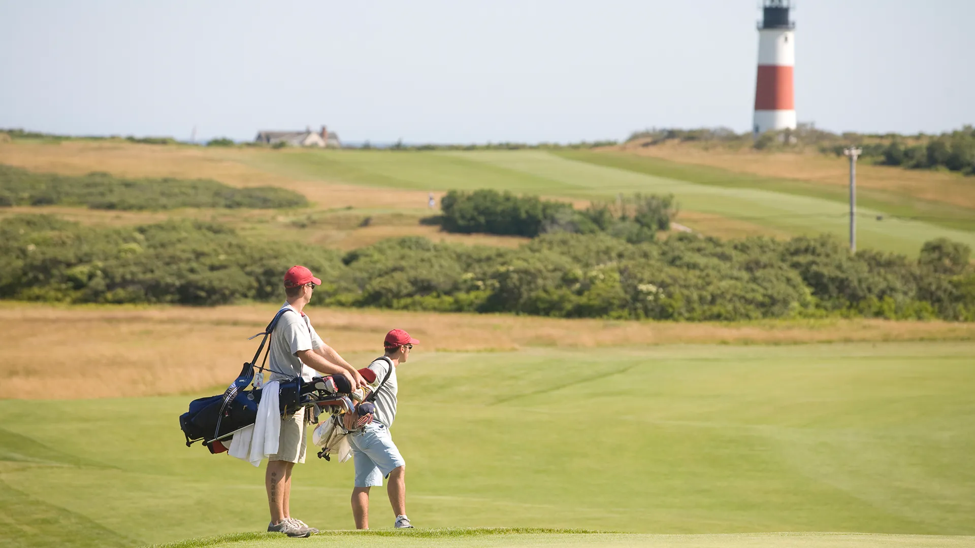 Golfers with lighthouse in the background